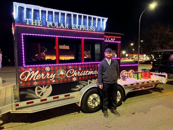 Christmas Parade float of the Polar Express with a man standing in front of float